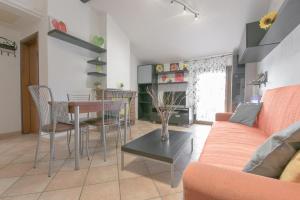 a living room with a couch and a table at Queen Home Funo Centergross in Castel Maggiore