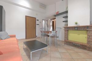a living room with a couch and a fireplace at Queen Home Funo Centergross in Castel Maggiore