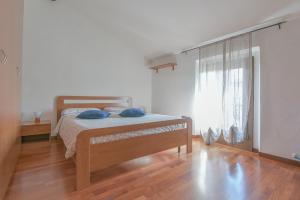 a bedroom with a bed with blue pillows on it at Queen Home Funo Centergross in Castel Maggiore +5 photos