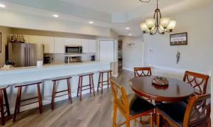 a kitchen and dining room with a table and chairs at Waters Edge in Lake Ozark