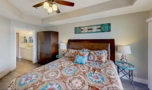 a bedroom with a bed and a ceiling fan at Waters Edge in Lake Ozark