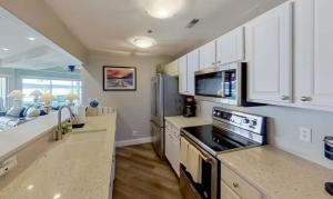 a kitchen with white cabinets and a counter top at Waters Edge in Lake Ozark