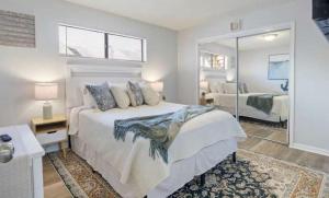 a bedroom with a large bed and a mirror at The Luxe Lakefront in Lake Ozark