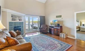 a living room with a couch and a fireplace at Lakeside Lookout in Sunrise Beach