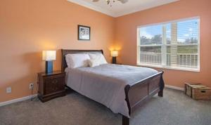 a bedroom with a bed with two lamps and a window at Lakeside Lookout in Sunrise Beach +22 photos