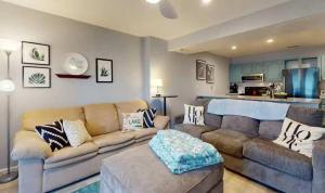 a living room with a couch and a kitchen at Lake Front Lookout in Lake Ozark