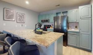 a kitchen with a granite counter top and a refrigerator at Lake Front Lookout in Lake Ozark