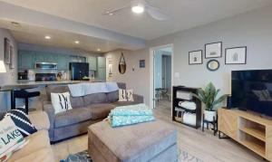 a living room with a couch and a tv at Lake Front Lookout in Lake Ozark