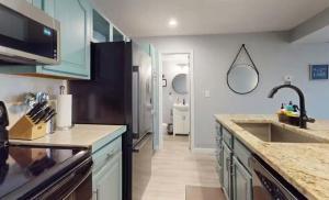 a kitchen with a sink and a counter top at Lake Front Lookout in Lake Ozark +20 photos