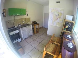 an overhead view of a kitchen with green cabinets at Canto da Onda - Trilha exclusiva para a praia in Marechal Deodoro