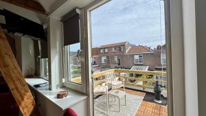 a room with a window and a view of a balcony at Stationbeds Studio-2 Alkmaar in Alkmaar