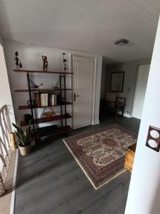 a living room with a door and a rug at Trégouët 8 - Chambre 2 in Saint-Nazaire +2 photos