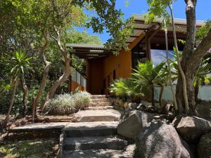 a house with a stone path leading to a house at Rainbow Valley Lodge Costa Rica in Monteverde Costa Rica