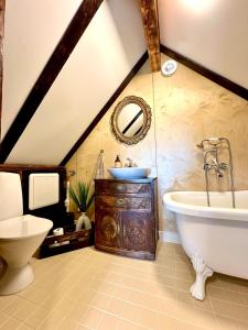 a bathroom with a bath tub and a sink at Fjord Panorama Lodge in Strand