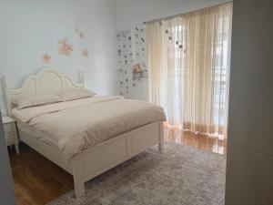 a bedroom with a bed and a window at Piraeus new hotel in Piraeus