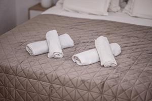 a group of rolled towels on a bed at Mikuljan Apartments- Free Parking -5 Min by Walk to Beach in Stobreč