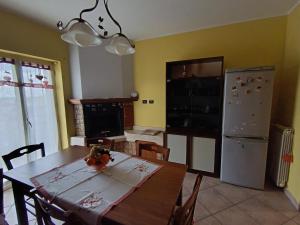 a kitchen with a wooden table and a refrigerator at Sara's Home Vetralla in Vetralla