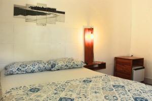 a bedroom with a bed with two pillows on it at Canto da Onda - Trilha exclusiva para a praia in Marechal Deodoro +20 photos