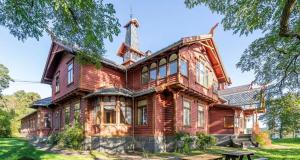 a large wooden house with a tower at Casa Brekka in Bamble