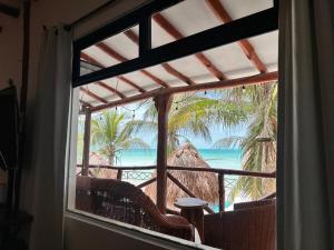 a window view of the ocean from a resort at Choby's House Holbox in Holbox Island
