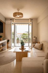 a living room with a couch and a table at VERADO by A&D Properties in Porto Rafti