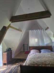 a bedroom with a bed in a attic at La Chaumière in Fréhel +7 photos