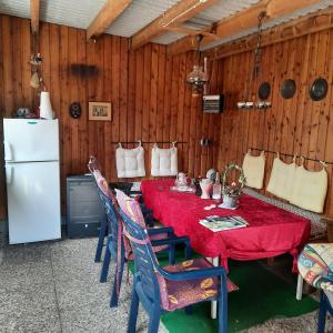 a dining room with a red table and chairs at Kulumheide in Löwenstedt