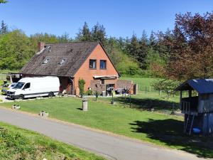 a white van parked in front of a house at Kulumheide in Löwenstedt