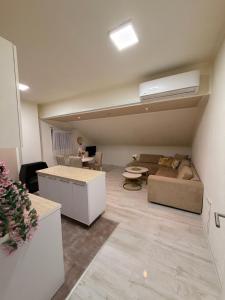 a living room with a couch and a table at Apartman Maja in Prijedor