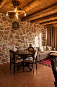 a living room with a table and chairs and a couch at Villa Lugina e Kuajve Bulqize in Bulqizë +27 photos