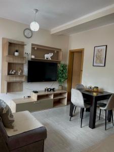 a living room with a flat screen tv and a table at Apartments Marash in Kotor