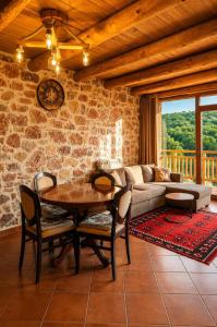 a living room with a table and a couch at Villa Lugina e Kuajve Bulqize in Bulqizë