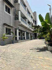 a cobblestone street in front of a building at Stepping Stone Apartments in Bijilo