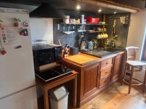 a kitchen with a sink and a counter with a microwave at Villa Blanco in Opwijk +21 photos