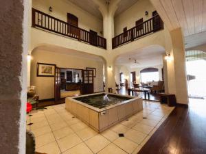 a large room with a hot tub in the middle of a building at Villa Azulejo in Black Rock