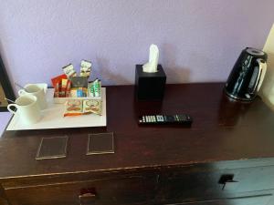 a table with a candle and other items on it at Gillygate Guest House in York
