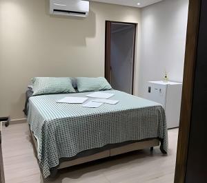 a bedroom with a bed with sheets and papers on it at Madonna Prime Studio Hotel Extrema MG + breakfast in Extrema