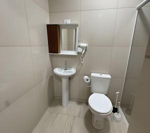 a small bathroom with a toilet and a sink at Madonna Prime Studio Hotel Extrema MG + breakfast in Extrema +32 photos