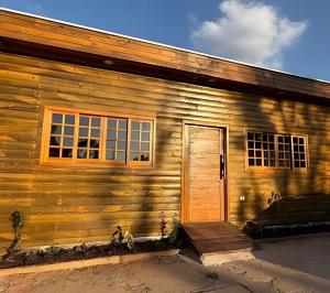 a wooden house with a door on the side of it at Madonna Prime Studio Hotel Extrema MG + breakfast in Extrema