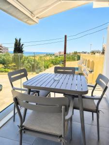 a picnic table and two chairs on a balcony at Green Bay Suites in Protaras +59 photos