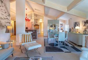 a living room with a table and chairs and a kitchen at Appartement DELICE A in Saint-Tropez