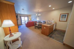a kitchen and living room with a table and a couch at Red Hawk Lodge 2297 by SummitCove Lodging in Colorado in Keystone