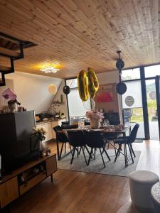 a living room with a dining room table with chairs at LAKEVIEW A-frame ESCAPE in Tisa