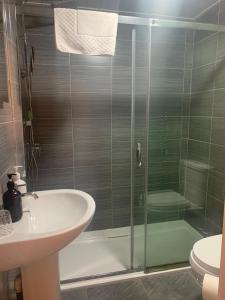 a bathroom with a shower and a sink and a toilet at Gillygate Guest House in York +32 photos