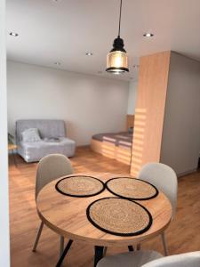 a wooden table and chairs in a living room at NV Apartments 2 in Volodymyr-Volynskyi