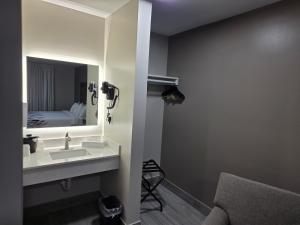 a bathroom with a sink and a mirror and a bed at Red Roof Inn Green Brook - Somerset in Green Brook +12 photos