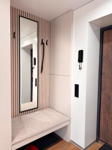 a dressing room with a mirror on the wall at NV Apartments 2 in Volodymyr-Volynskyi