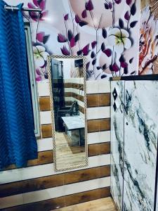 a mirror on the side of a room with flowers at K D Dham Hotel- Near Prem Mandir & Iskcon Temple Vrindavan in Vrindāvan