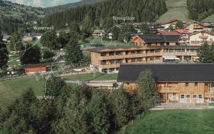arial view of a hotel in a mountain village at Mariengut - Natur Aparthotel Kramer in Wagrain