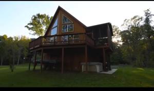 a house with a balcony and a horse in the yard at Green Castle cabin on the Shenandoah River in Luray